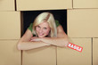 Woman stood amongst cardboard boxes