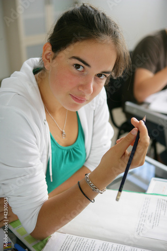 Photo: Teenage girl writing in an exam Teenage girl writing in an exam