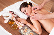 Beautiful young woman getting shoulder massage