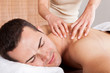 Photo: Young man getting shoulder massage Young man getting shoulder massage
