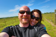 Happy couple wearing sunglasses at a winery