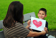 Son giving mom heart drawing
