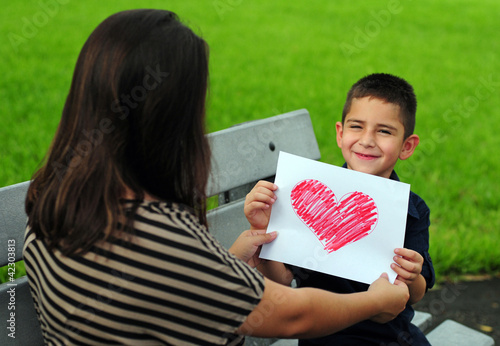Photo: Son giving mom heart drawing Son giving mom heart drawing