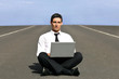 Man alone with laptop on airstrip