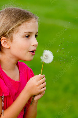 Photo: Summer joy - lovely girl blowing dandelion Summer joy - lovely girl blowing dandelion