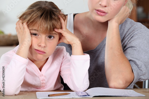 Foto: Little girl bored of her homework Little girl bored of her homework