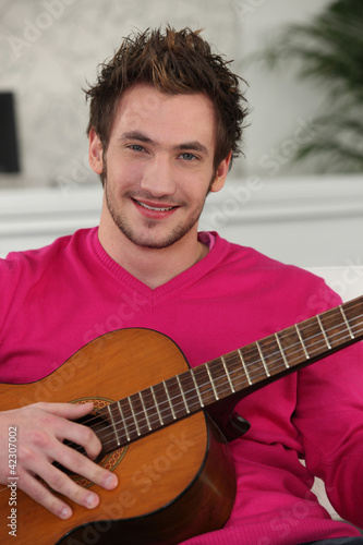 Photo: Young man playing the guitar Young man playing the guitar
