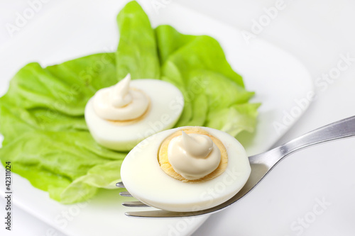 Photo: eggs with mayonnaise on fork eggs with mayonnaise on fork