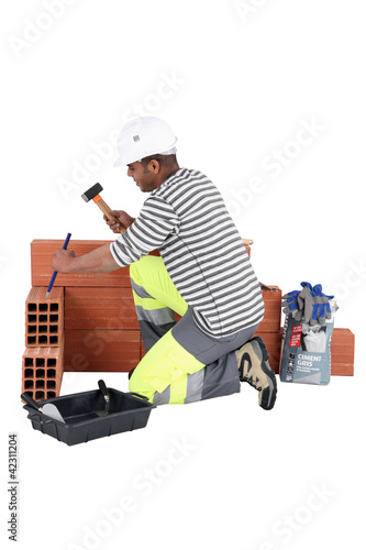 Photo: Man chiseling away at aerated brick Man chiseling away at aerated brick