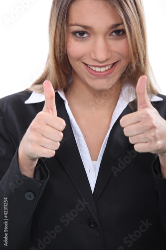 Photo: Happy businesswoman giving thumbs up gesture Happy businesswoman giving thumbs up gesture