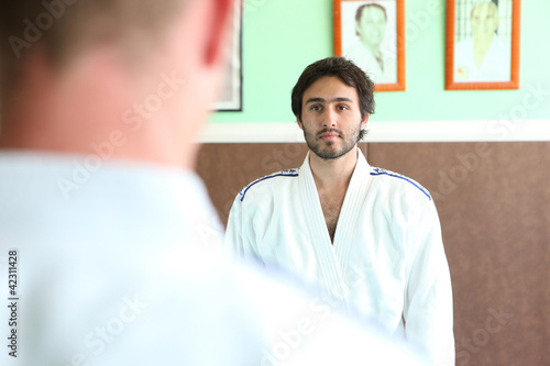 Photo: Men preparing for a b out of judo Men preparing for a b out of judo