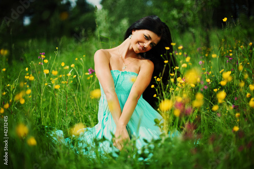 Photo: woman on summer flower field woman on summer flower field
