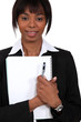 Businesswoman holding notepad and pen
