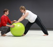 Pregnant woman exercising with personal trainer