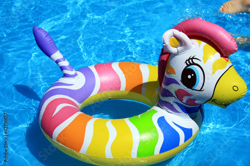 Photo: Toy and blue water in the swimming pool Toy and blue water in the swimming pool