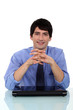 Relaxed man sitting at a desk
