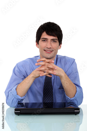 Photo: Relaxed man sitting at a desk Relaxed man sitting at a desk