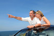 Senior couple in convertible car enjoying day trip