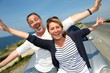 Senior couple in convertible car enjoying day trip