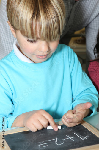 Photo: Portrait of a boy counting with his fingers Portrait of a boy counting with his fingers