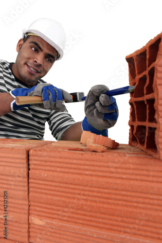 Photo: Mason carving bricks Mason carving bricks