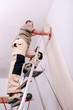 Wall papering man