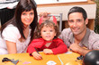 Little boy and parents getting ready for Halloween