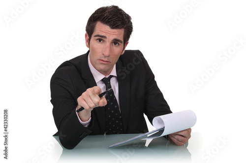 Photo: A businessman pointing at the camera. A businessman pointing at the camera.