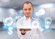 Adult business man holding tablet computer and different icons o
