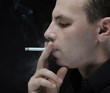young man smokes a cigarette
