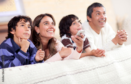 Photo: Family watching tv Family watching tv