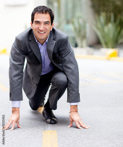 Photo: Businessman in racing position Businessman in racing position