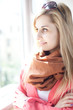 beautiful young woman looking through the window