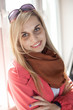 beautiful young woman with folded arms looking at camera