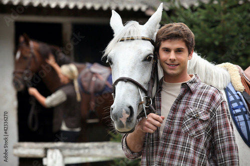 Photo: A young man with a horse. A young man with a horse.