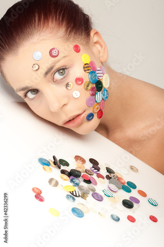 Photo: Beautiful woman with buttons on her face Beautiful woman with buttons on her face