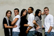 Trendy young people gathered by wall