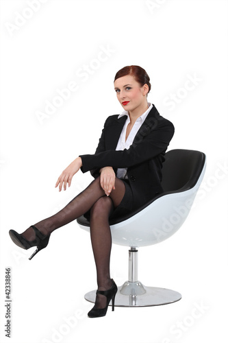 Photo: Businesswoman sat in swivel chair Businesswoman sat in swivel chair