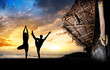 Yoga silhouettes on the beach
