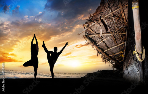 Photo: Yoga silhouettes on the beach Yoga silhouettes on the beach