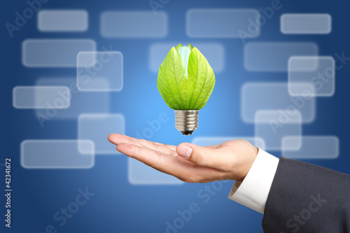 Photo: Concept of energy saving light bulbs on Business hand Concept of energy saving light bulbs on Business hand