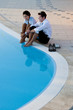 Young couple relaxing by pool