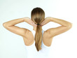 Pretty woman is stretching her spinal and her neck