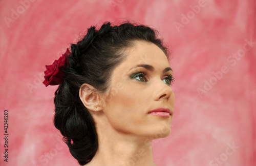 Photo: Portrait of brunette woman on a pink background Portrait of brunette woman on a pink background