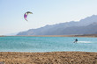 kitesurfer in lagoon surrounded by desert mountains