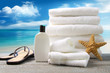 Photo: White towels and sandals with ocean scene White towels and sandals with ocean scene