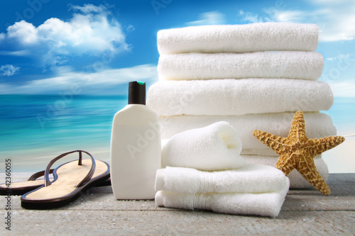Foto: White towels and sandals with ocean scene White towels and sandals with ocean scene