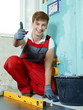 Apprentice for sanitary installations at work shows thumb up