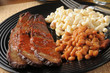 Closeup up of beef brisket with baked beans