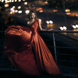 Sexy young beauty woman in fluttering red dress